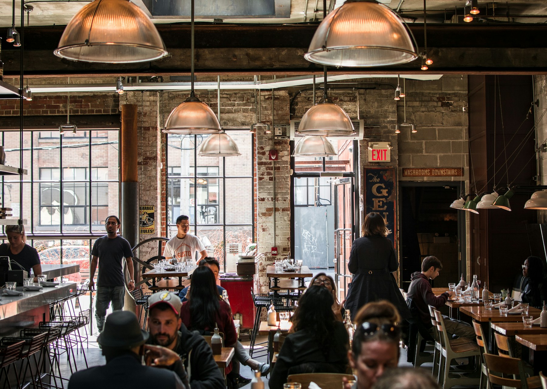 Busy restaurant dining room with guests and staff