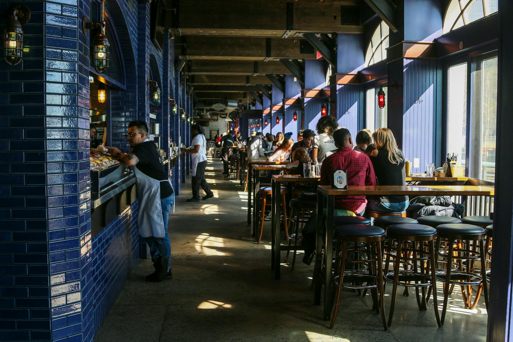 Busy restaurant dining room with guests eating during service